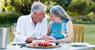 Buy stock photo Date, backyard and old couple with love, food and bonding together with celebration. Retirement, senior man or mature woman with champagne, outdoor or romance with relationship, marriage or smile