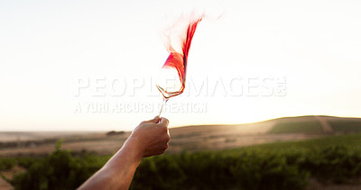 Buy stock photo Hand, red wine and person splash with glass at vineyard, luxury drink and farm or countryside. Winery, tourist and tasting alcohol outdoor or swirl beverage with mockup space at sunset in nature