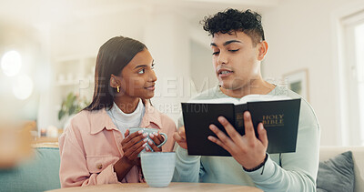Buy stock photo Home, reading bible or couple in lounge, religion or scripture with guidance. People, apartment or man with woman, coffee or learning with holy book, Christianity gospel or praise together with faith