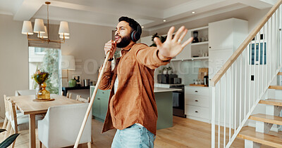 Buy stock photo Headphones, sing and sweeping with man in home for chores, responsibility or spring cleaning. Broom, dance and music with happy person in apartment for housekeeping, listening or radio streaming