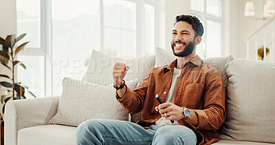 Buy stock photo Fist pump, support and television with man on sofa in home living room for subscription service. Celebration, streaming and watching tv with sports fan cheering or celebrating success in apartment