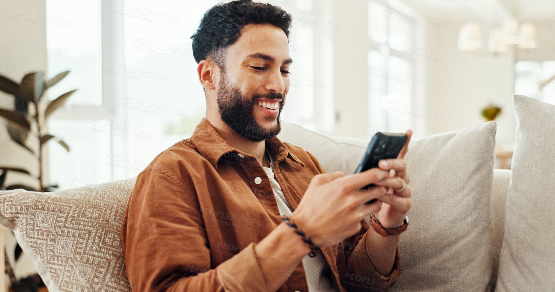 Buy stock photo Online, smartphone and happy man relax in home for social media app, message response or reading ebook. Mobile, sofa and person on website for communication, chat notification or news on internet