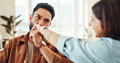 Buy stock photo Smile, couple and kiss hand at house for affection, passion and partner love for support in living room. People, romance and bonding together for relationship commitment, connection and weekend break