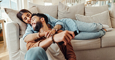 Buy stock photo Love, happy and couple in home, bonding and relax in living room with smile, man and woman on break. Embrace, comfortable and people in relationship on couch, weekend and conversation in house
