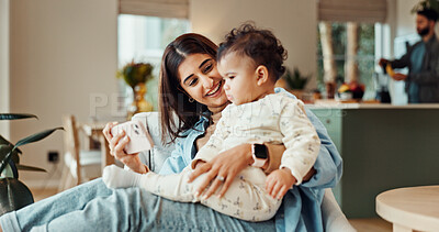 Buy stock photo Mother, baby and phone on sofa, happy and relax with video, cartoon and streaming in living room. Woman, mom and infant girl with smartphone, app and subscription on couch in lounge at family house