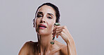 Beauty, jade roller and portrait of woman in studio for antiaging cosmetics or dermatology. Gua sha, facial massage and skincare with person on gray background for crystal stone face treatment