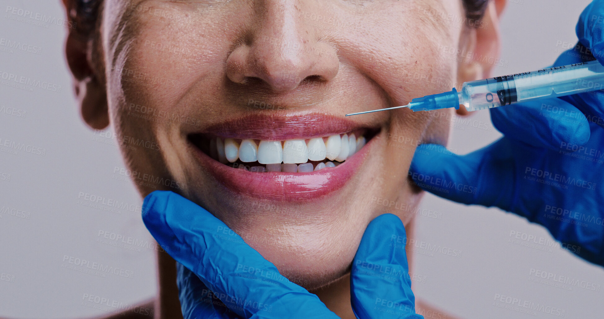 Buy stock photo Woman, skincare and injection in studio for lip filler, relax and antiaging treatment. Mature model, surgeon hands or needle on white background for cosmetology, transformation or plastic surgery