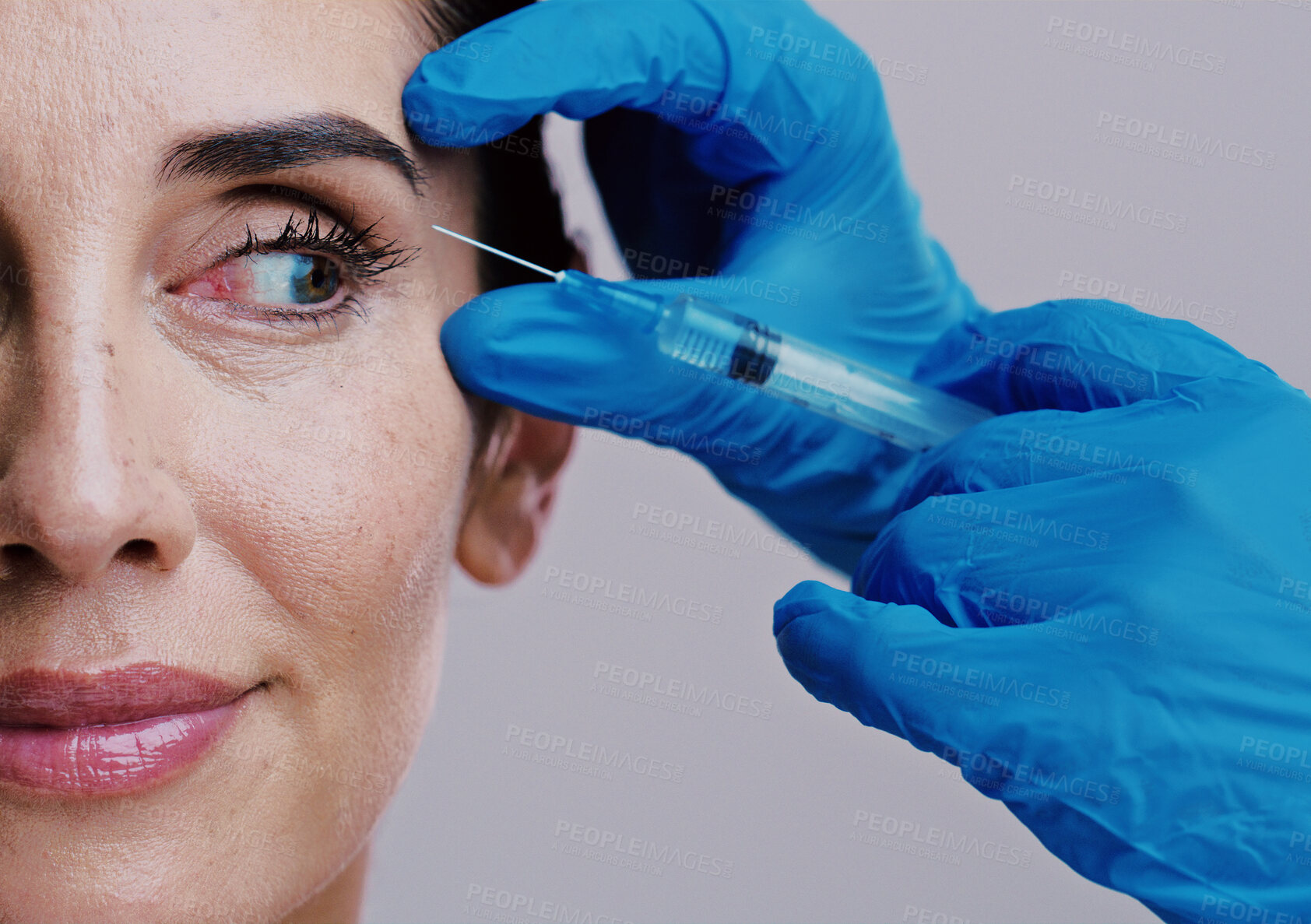 Buy stock photo Woman, skincare and injection in studio for dermal filler, crows feat and antiaging eyes treatment. Mature model, surgeon hands or needle on white background for cosmetology and plastic surgery