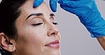 Woman, skincare and needle in studio for plastic surgery, relax and antiaging treatment. Mature model, surgeon hands or injection on white background for cosmetology, transformation or dermal filler