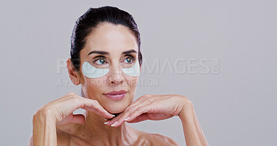 Beauty, mature woman and eye patches in studio for wrinkle reduction, firm skin treatment or hyaluronic acid. Mockup, person and confidence with cosmetics product for dark circles on white background
