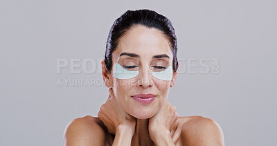 Buy stock photo Beauty, skincare and woman with eye patches in studio for collagen treatment, puffiness reduction and self care. Mockup space, mature person and cosmetics product for anti aging on white background