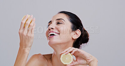 Buy stock photo Wellness, skincare or woman with lemon for beauty, cosmetics or facial treatment in studio. Dermatology, spa or mature person with fruit for vitamin C, organic or natural benefits on white background