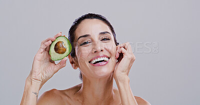 Buy stock photo Laugh, skincare and portrait of woman with avocado for beauty, cosmetics and facial treatment in studio. Dermatology, spa and person for vitamins, organic and natural benefits on white background