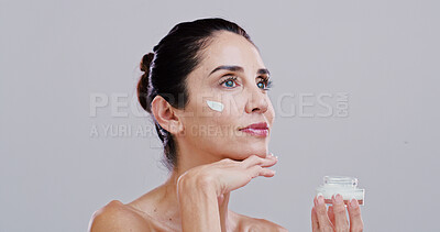 Buy stock photo Skincare, cosmetics and woman with face cream in studio for collagen treatment, wrinkle reduction or anti aging. Mockup, mature person or beauty product for skin hydration or glow on white background