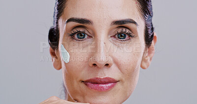 Buy stock photo Skincare, beauty or mature woman with face cream for anti aging treatment, wrinkle reduction or portrait. Studio, moisturiser and facial cosmetics application for hydration lotion on white background