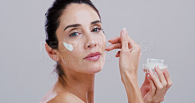 Buy stock photo Cosmetics, skincare and woman with face cream in studio for anti aging treatment, wrinkle reduction or retinol. Space, mature person and portrait with beauty product for hydration on white background