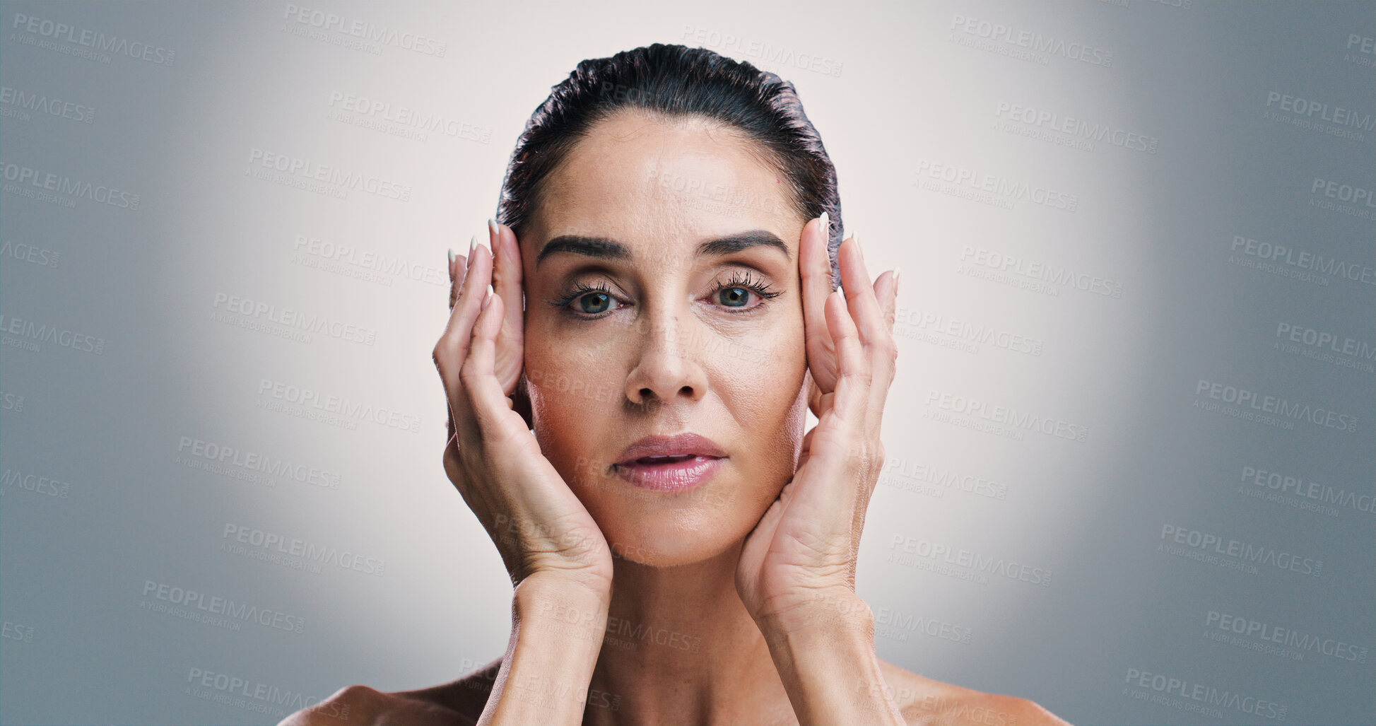 Buy stock photo Cosmetics, portrait and skincare with woman in studio for antiaging treatment or wellness routine. Hands, beauty and dermatology with mature model on gray background for facial transformation