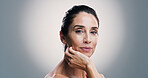 Beauty, cosmetics and portrait of woman in studio for antiaging treatment or wellness routine. Aesthetic, dermatology and skincare with mature model on gray background for facial transformation