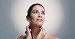 Skincare, thinking and woman with beauty, dermatology and idea for anti aging treatment. Mature model, natural cosmetics and facial glow for self care, wellness and health on gray studio background