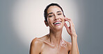 Skincare, portrait and woman laugh with beauty, glow and anti aging treatment. Mature model, natural cosmetics and facial dermatology for aesthetic, happiness and shine on gray studio background