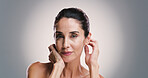 Natural skincare, portrait and woman with glow, dermatology and treatment for anti aging. Mature model, confident face and beauty cosmetics, aesthetic or skin texture on gray studio background space