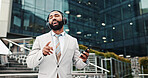 Singing, man and phone with headphones in city for music playlist, streaming audio and work break outdoor. Business, professional and dancing to track for sound subscription or listening to radio app