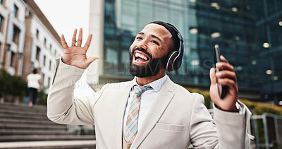 Buy stock photo Dancing, man and phone with headphones in city for music playlist, morning energy and streaming audio. Business, happy person and singing outdoor for radio track, sound subscription and work break