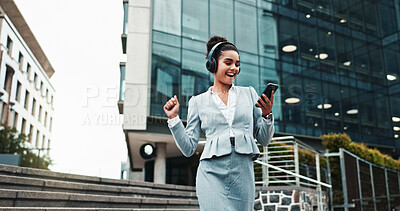 Buy stock photo Woman, phone and dancing with headphones outdoor for music, work break and streaming audio. Business, happy person and energy with sound subscription, celebration and listening to radio app in city