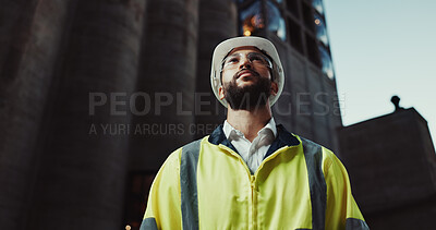 Buy stock photo Man, engineer and thinking in city with helmet for urban expansion, construction and low angle by building. Person, architect and perspective in street, town and infrastructure inspection in Colombia