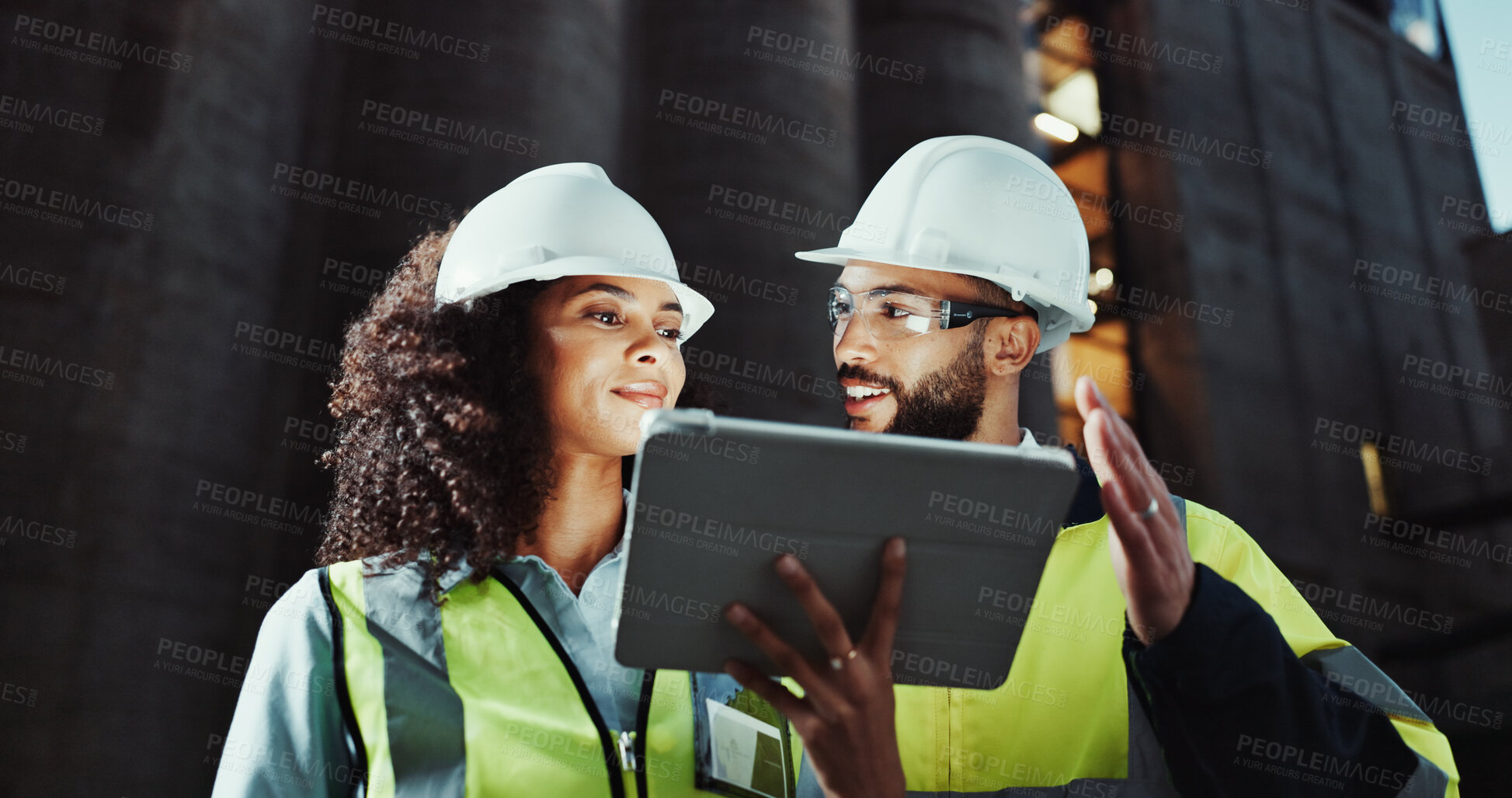 Buy stock photo Man, woman and engineer on tablet in city, smile or planning for urban expansion at construction site. People, architect and touchscreen at night, team and app for infrastructure inspection in Brazil