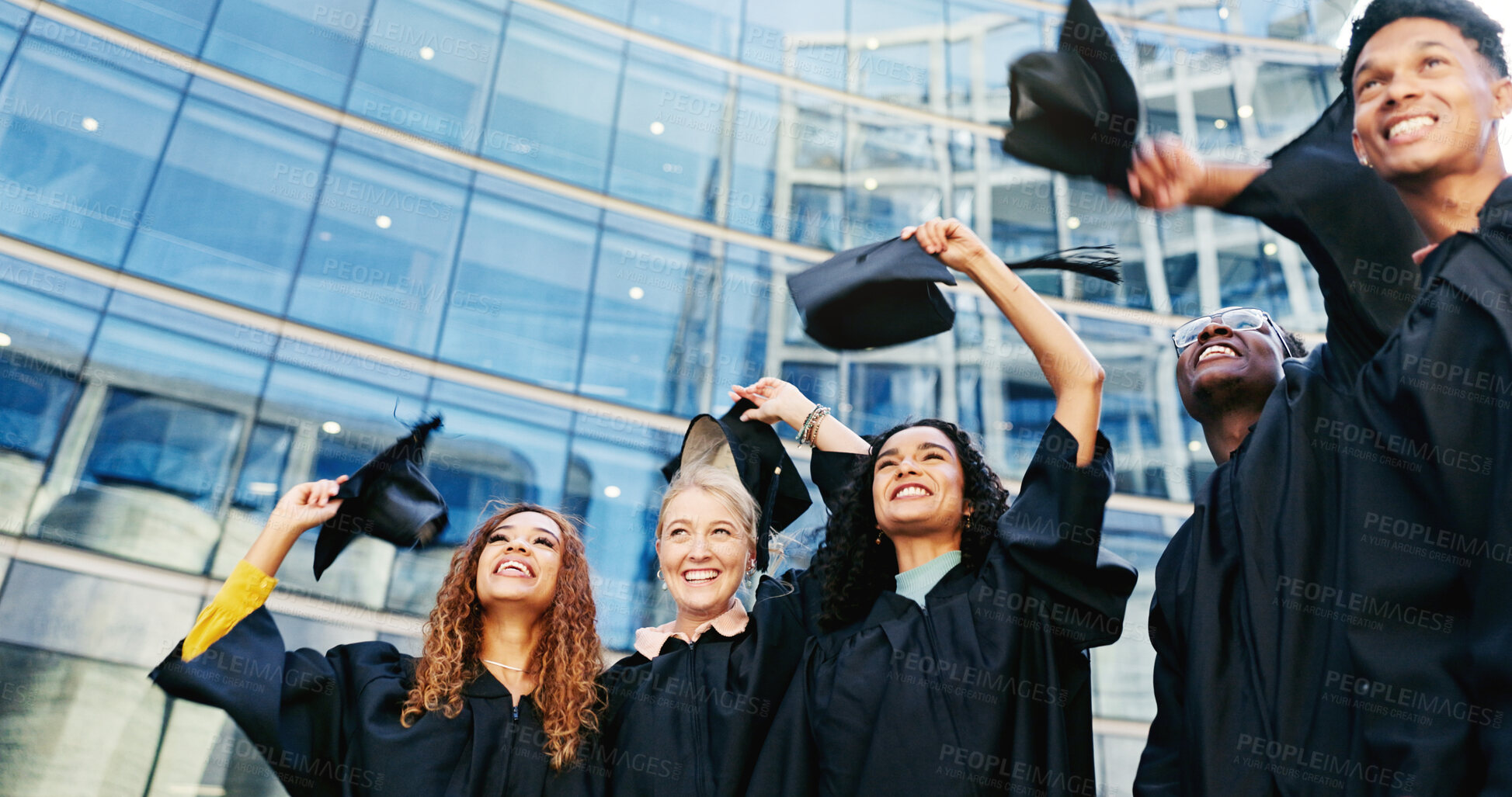 Buy stock photo Happy, students and throw hats for graduation of learning success, class achievement and celebrate. Below, people and tradition with support, academic degree and bonding together for college ceremony