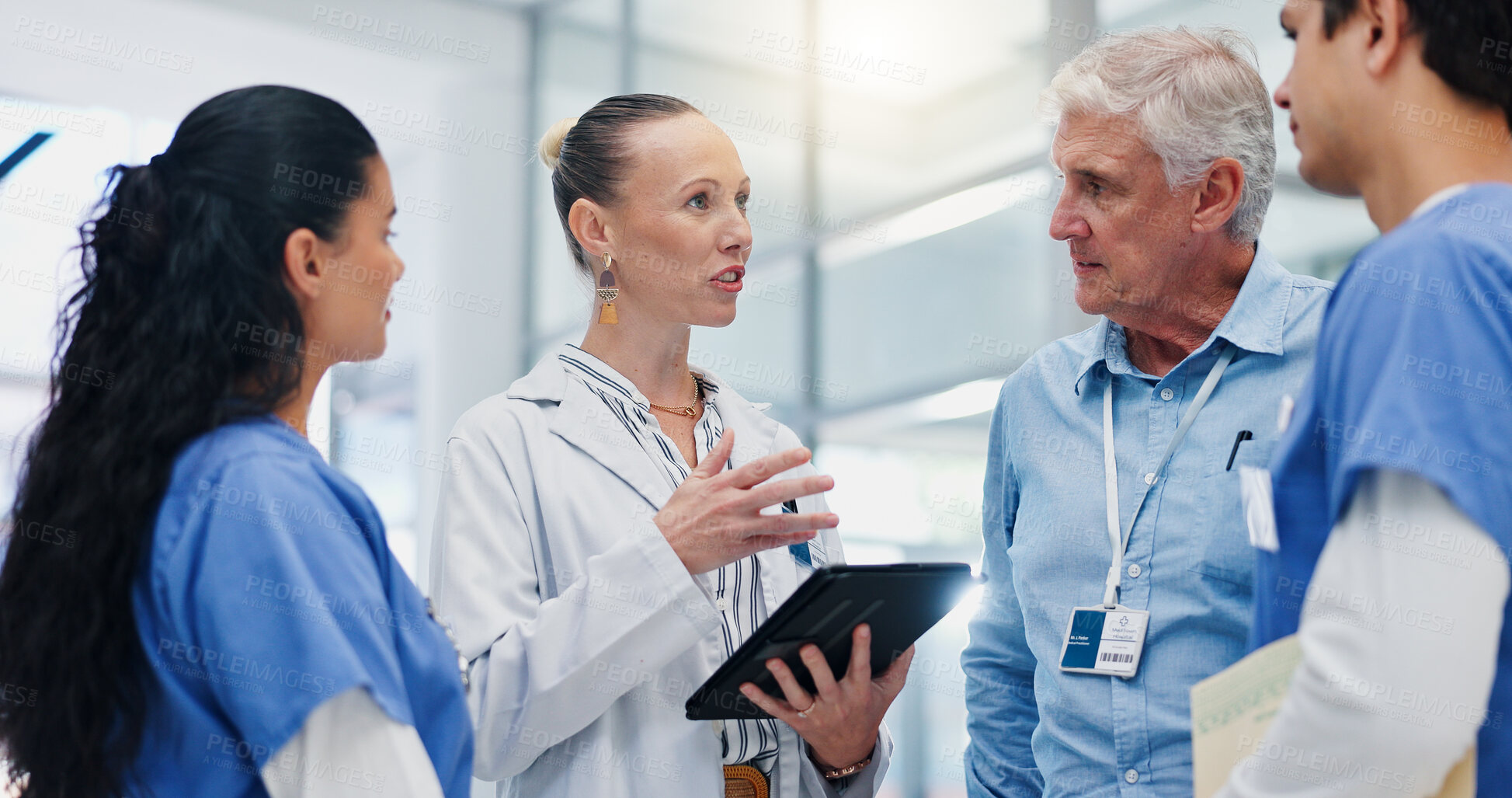Buy stock photo Doctors, team and tablet for hospital management with discussion for funding, planning and review. People, leader and group with surgeon, problem solving and feedback with app at wellness clinic