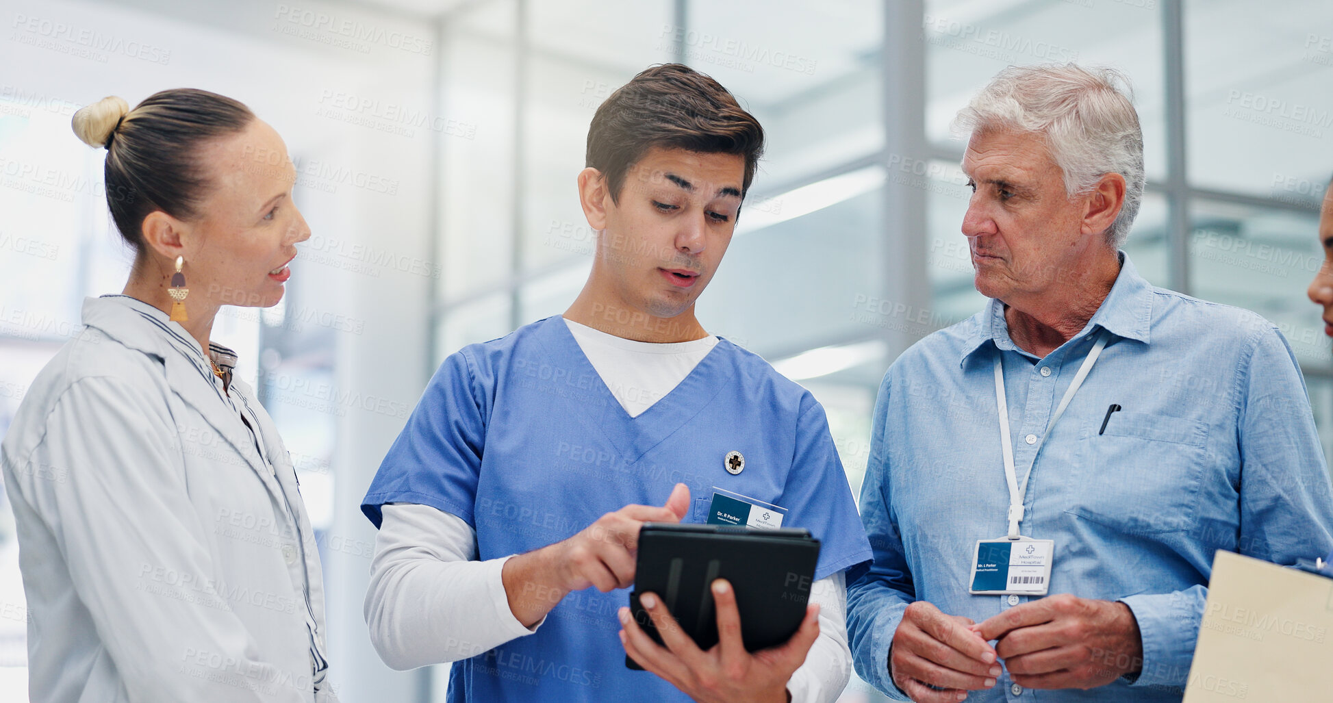 Buy stock photo Man, doctors and tablet with group at hospital with discussion for funding, management and review. People, leader and team with surgeon, problem solving and feedback with app at wellness clinic