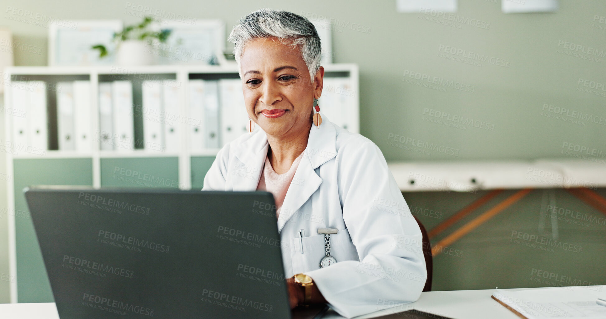 Buy stock photo Laptop, woman and doctor in workplace, healthcare or research for diagnosis, internet or treatment. Mature person, medical or professional with pc, online reading or email for test results and cure