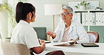 Appointment, clipboard or healthcare with doctor and patient in office of hospital for consulting. Conversation, insurance or medical with mature medicine professional and woman in clinic for update