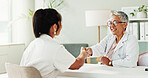 Appointment, handshake or healthcare with doctor and patient in office of hospital for consulting. Conversation, medical or meeting with mature medicine professional and woman shaking hands in clinic