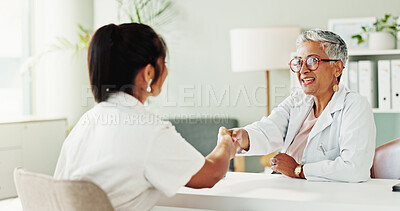 Buy stock photo Appointment, handshake or healthcare with doctor and patient in office of hospital for consulting. Conversation, medical or meeting with mature medicine professional and woman shaking hands in clinic