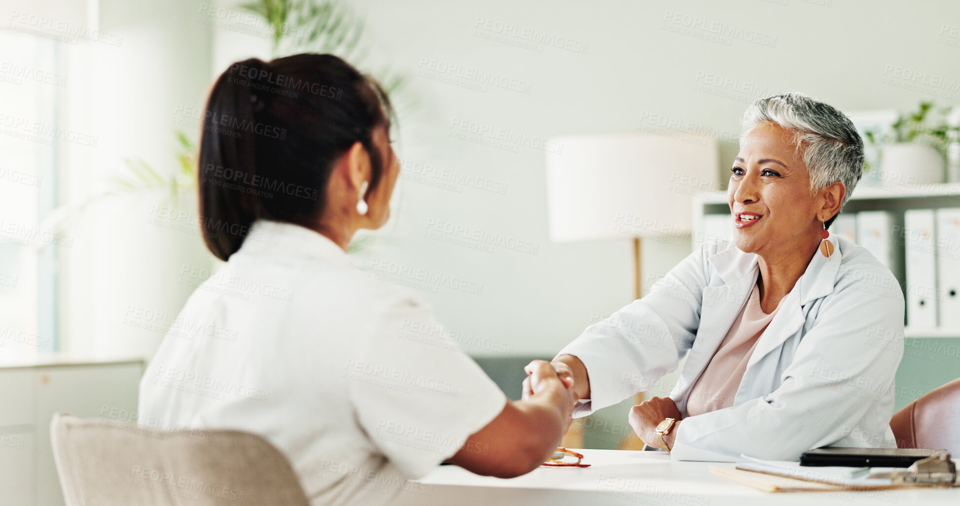 Buy stock photo Appointment, handshake or medical with doctor and patient in office of hospital for consulting. Healthcare, meeting or welcome with mature medicine professional and woman shaking hands in clinic