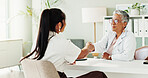 Appointment, healthcare or shaking hands with doctor and patient in office of hospital for consulting. Conversation, handshake or medical with mature medicine professional and woman meeting in clinic