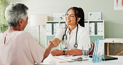 Buy stock photo Handshake, medical or senior care with doctor and patient in hospital office for consulting. Conversation, feedback or healthcare with medicine professional and mature woman shaking hands for welcome