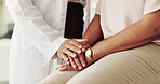 Closeup, patient and doctor with holding hands for empathy, kindness and support for cancer disease. People, client and medical employee with sorry for diagnosis, courage and illness in healthcare