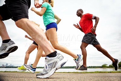 Buy stock photo People, fitness and running with legs in nature for outdoor workout, exercise or physical activity together. Athlete, runners or group with sprint for race, cardio training or health and wellness