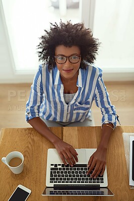 Buy stock photo Portrait, woman and top view with laptop, working and home with coffee, remote work and smile. African employee, typing and glasses for computer, online and electronic or freelancer, pc and digital