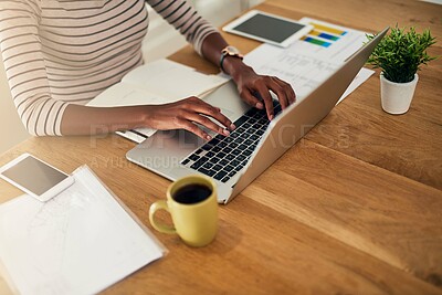 Buy stock photo Cropped shot of an unrecognizable woman working on her laptop at home