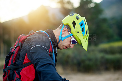 Buy stock photo Man, cyclist and nature with helmet for break, rest or recovery for mountain cycling. Male person, biker or catching breathe with safety or protection for adventure, extreme sport or outdoor fitness