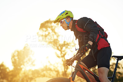 Buy stock photo Man, cyclist and sunset with mountain bike for extreme sport, fitness or outdoor exercise in nature. Active, male person or riding in wilderness with bicycle or helmet for cycling or adrenaline