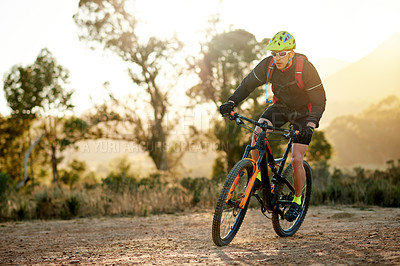Buy stock photo Man, cycling or mountain with bike for fitness, extreme sport or outdoor exercise in nature. Active, male person or cyclist riding with bicycle or helmet for adrenaline or cardio workout on dirt road