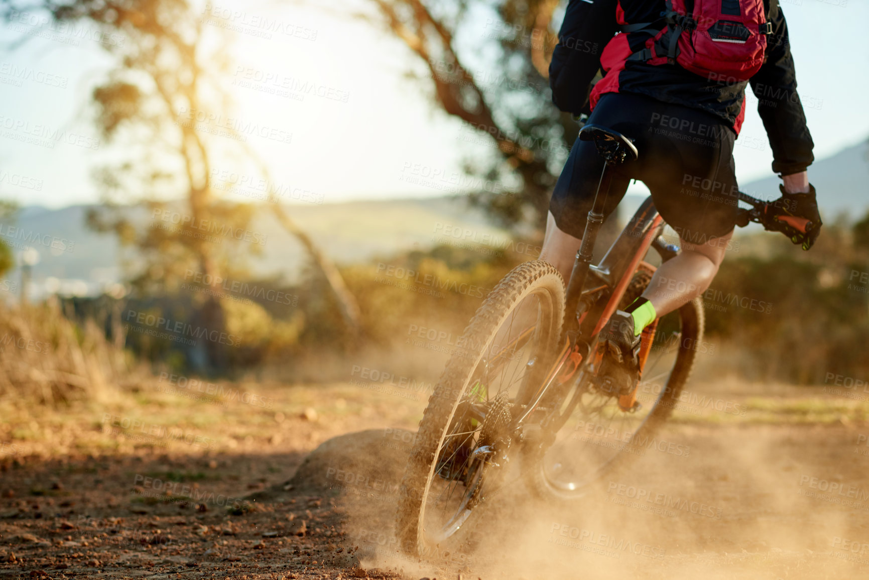 Buy stock photo Person, mountain bike and cycling with dirt road for extreme sport, fitness or cardio workout in nature. Active, cyclist or riding with bicycle or backpack for adrenaline rush or outdoor exercise