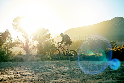 Buy stock photo Man, mountain bike or cycling with sunset on dirt road for fitness, extreme sport or cardio workout in nature. Active, cyclist or riding with bicycle for training, adrenaline rush or outdoor exercise
