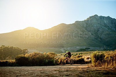Buy stock photo Bike, sports and view with man in mountains for adrenaline, adventure or training on dirt road. Exercise, fitness and scenic with person cycling in nature for challenge, competition or performance